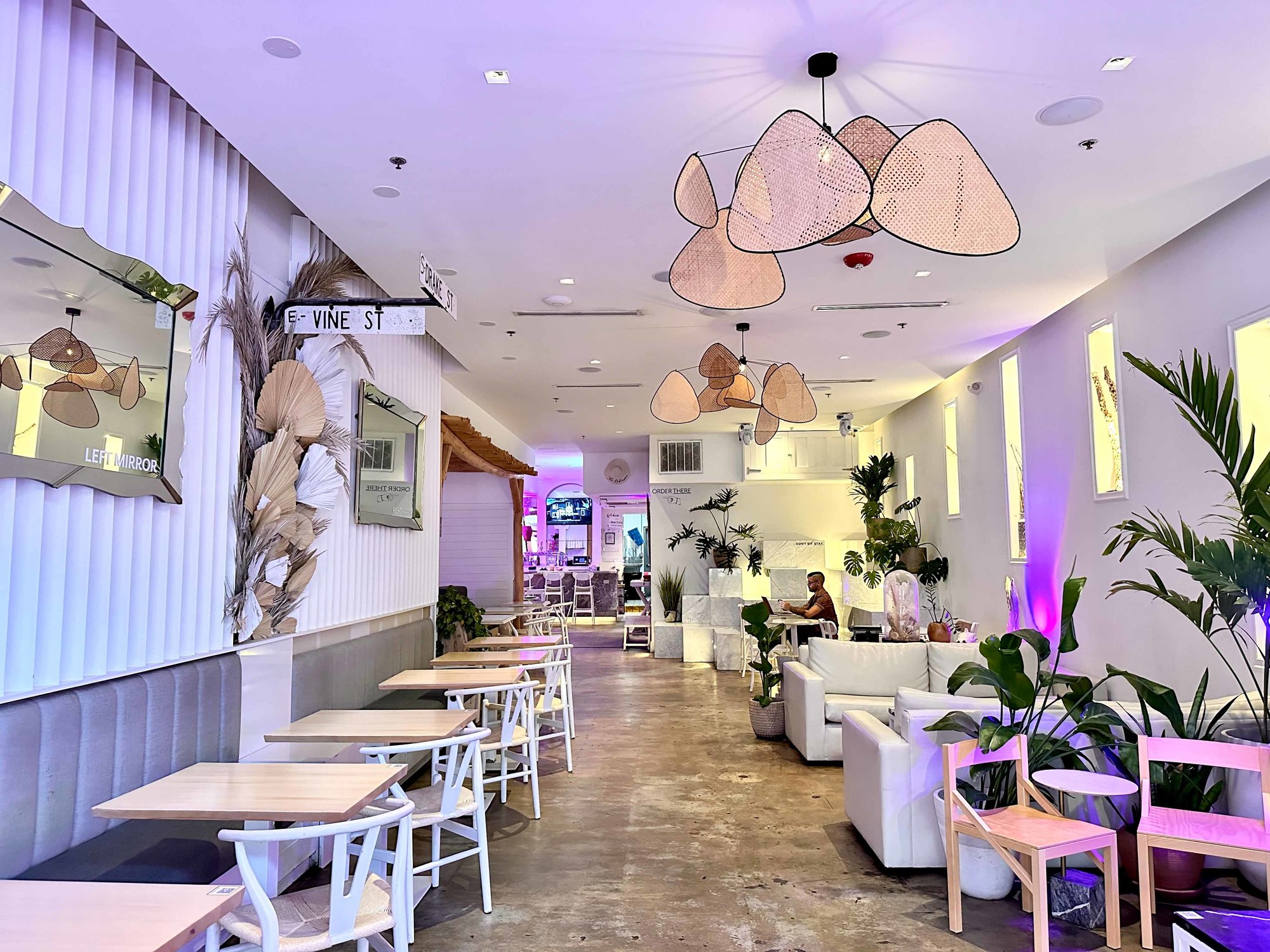 white walls and tables with brown accents and plants